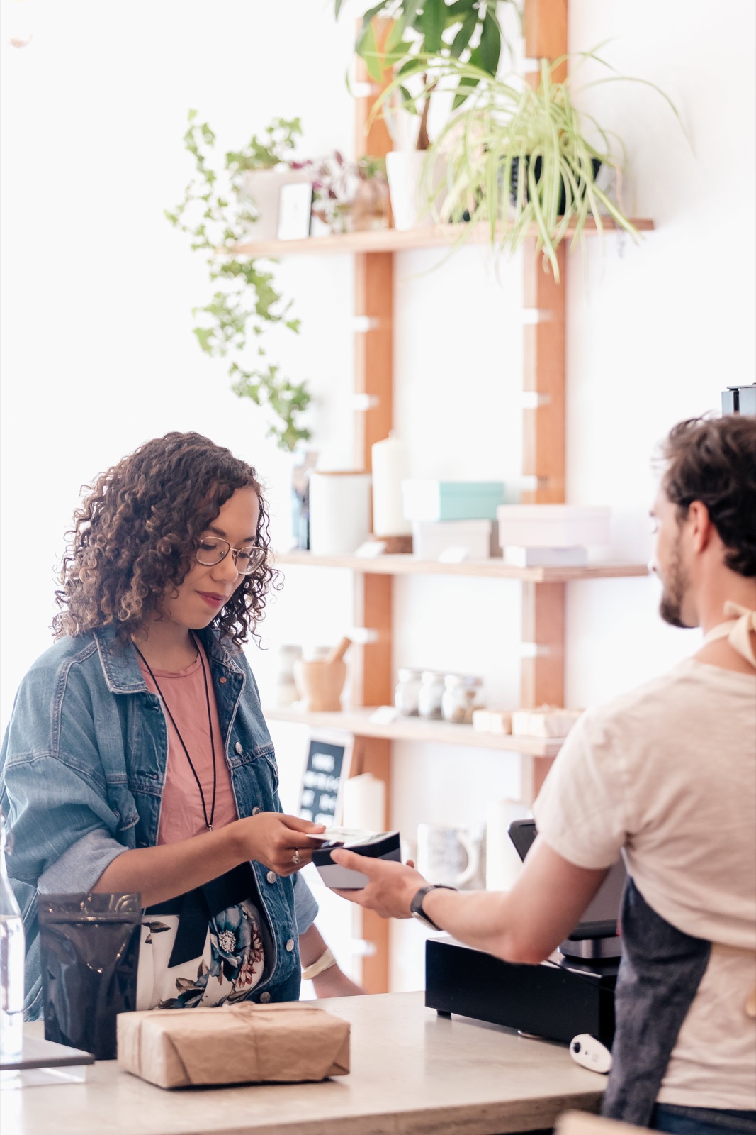 Customer paying at a small shop counter